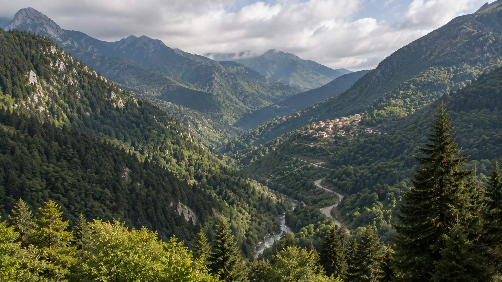 Forested mountain valley and traditional village in Evrytania, Greece