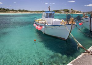 Traditional fishing boat in turquoise waters in Naxos, Cyclades, Greece