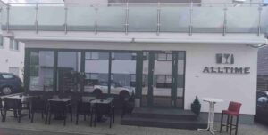 Front entrance of All Time Lounge Cafe in Leonberg with outdoor seating area and café terrace.