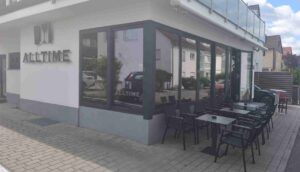 Side view of All Time Lounge Cafe in Leonberg showing the outdoor terrace and café seating area.