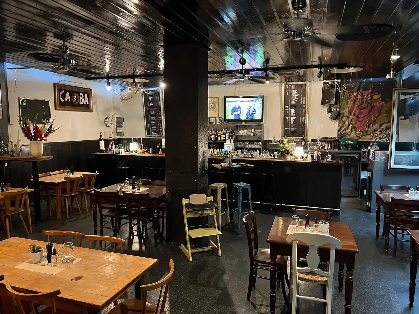 Interior of Akropolis Greek restaurant in Konstanz with dining tables, bar area and wall artwork