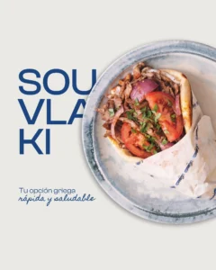 Greek pita filled with sliced meat, tomato, red onion and herbs at Egeo