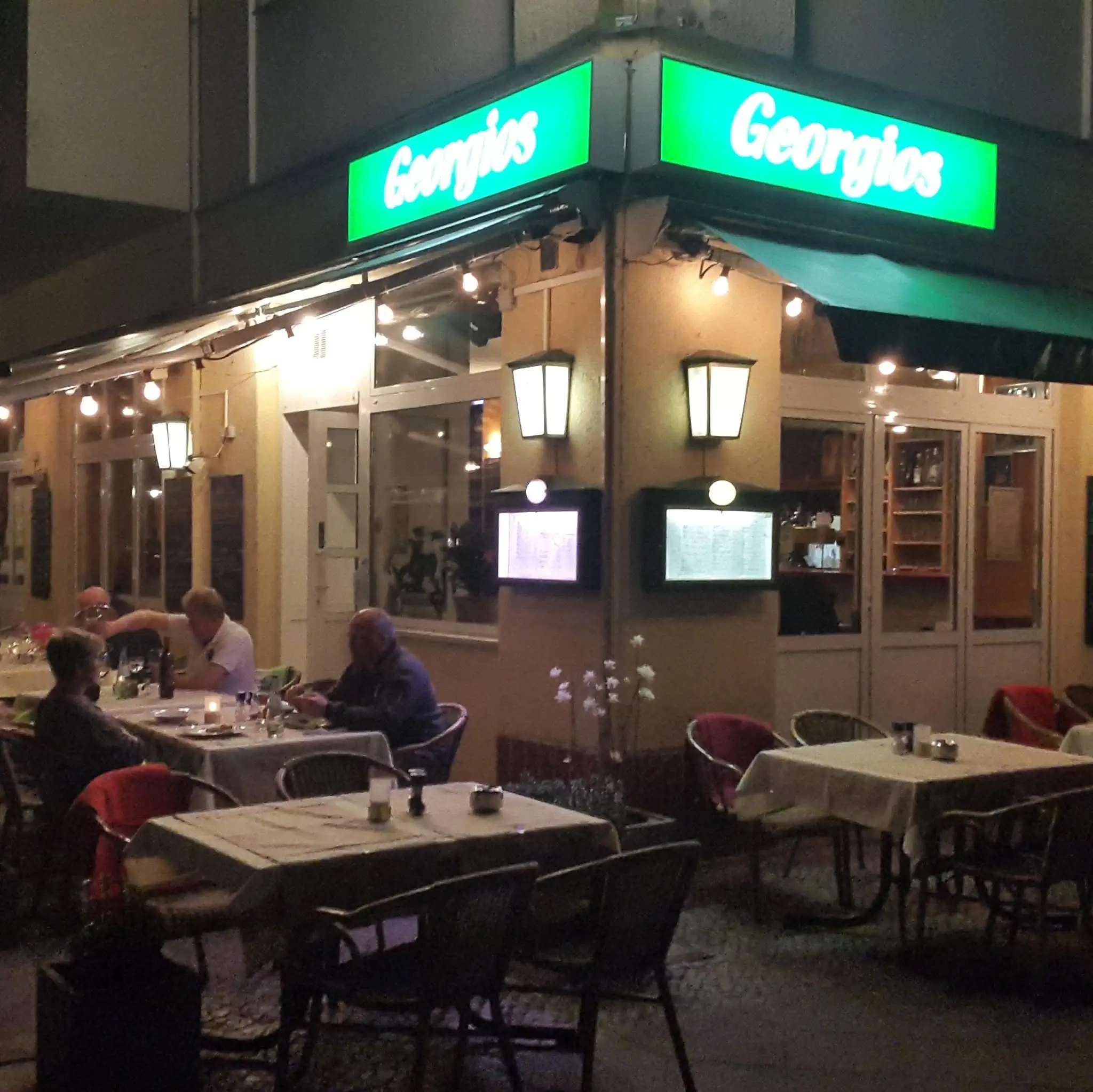 Evening exterior and outdoor seating area at Georgios Restaurant