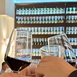 Red wine glasses with bottle display inside Georgios Restaurant