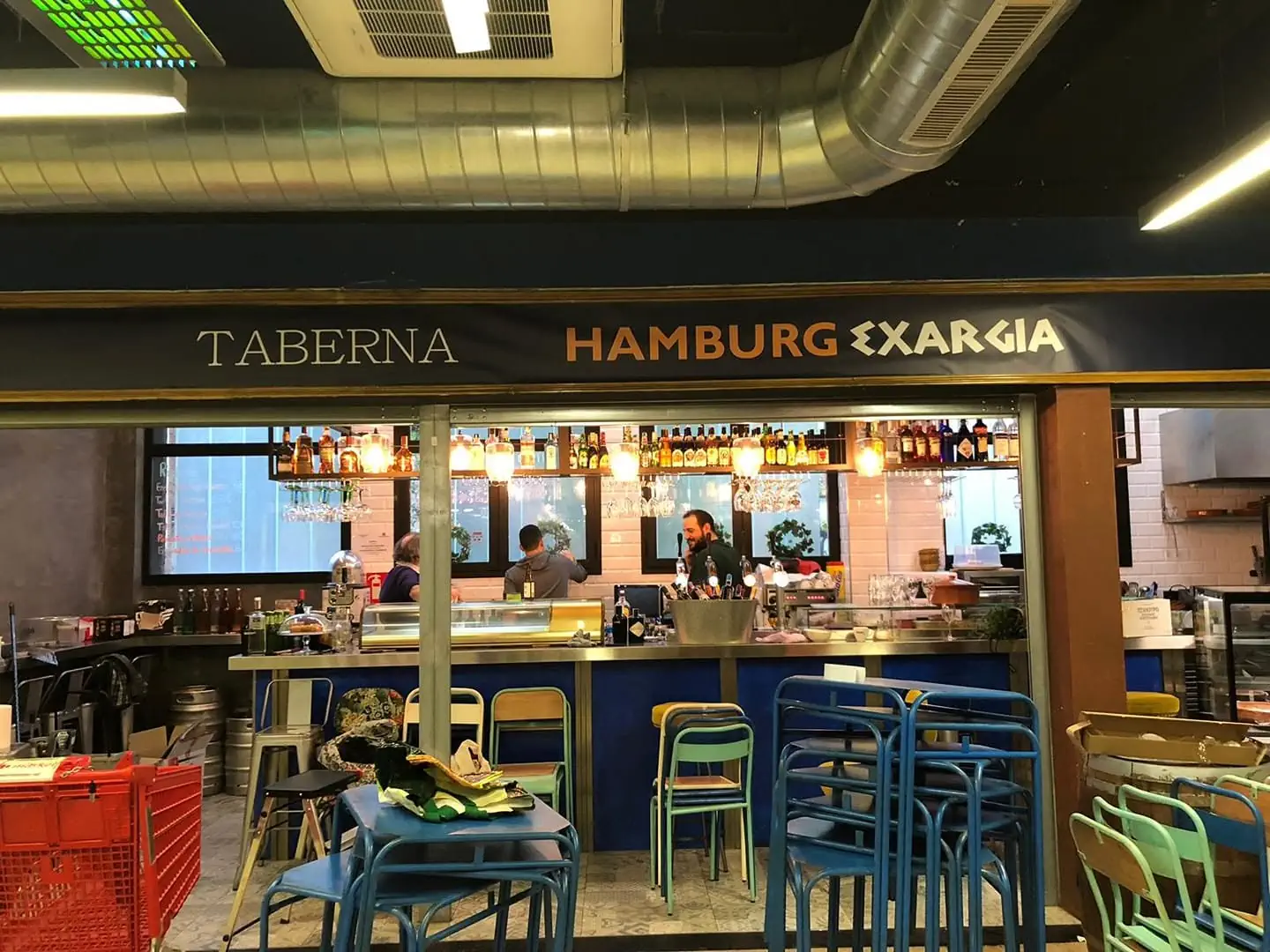 Interior of Hamburg Exargia with bar counter, tables and colourful seating