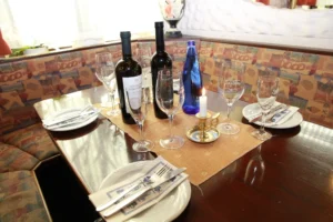 Prepared dining table with wine and glasses inside Helena