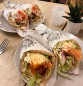 Greek pita wraps filled with meat, vegetables and sauce served at Mandrake
