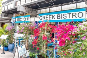 Exterior of Meraki Greek Bistro restaurant in Miami with colourful flowering plants