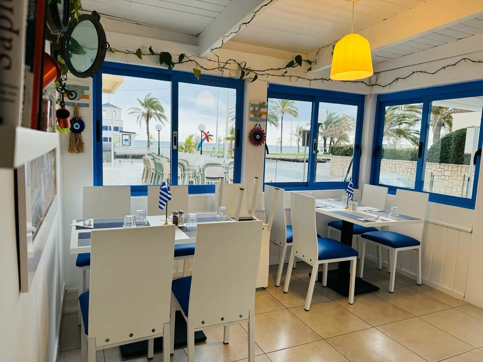 Bright dining interior with seafront views at Mykonos in Gandía