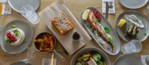 Overhead view of Greek-style dishes including a baked speciality and pita with vegetables and accompaniments at Le Syrtaki in Wavre