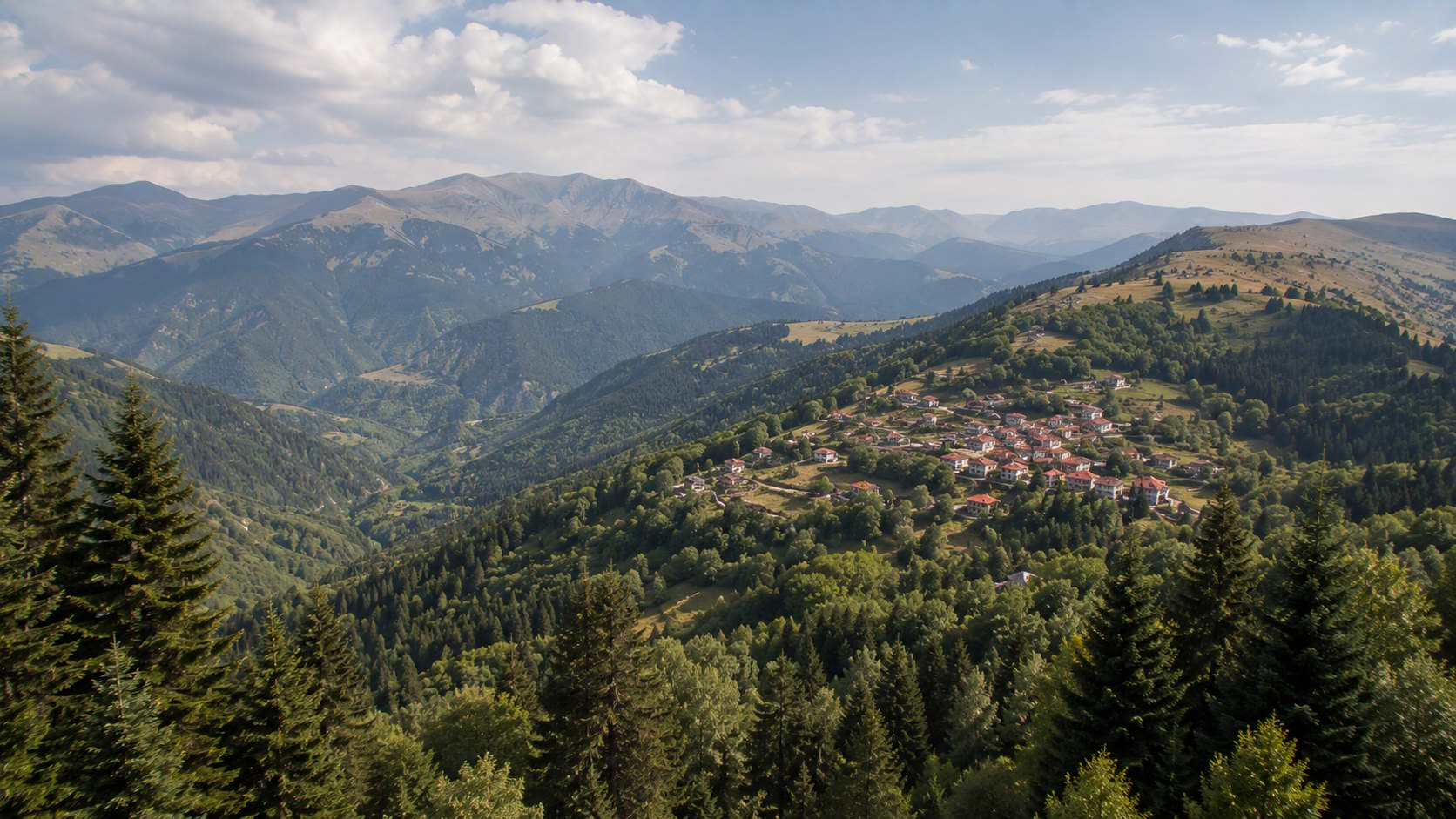 Forested mountain landscape and traditional village in Grevena, Greece