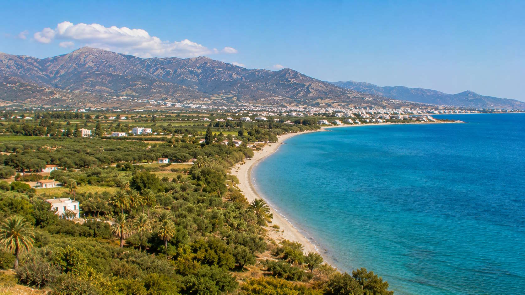 Coastal landscape with beach, green countryside and mountains in Kos, Greece