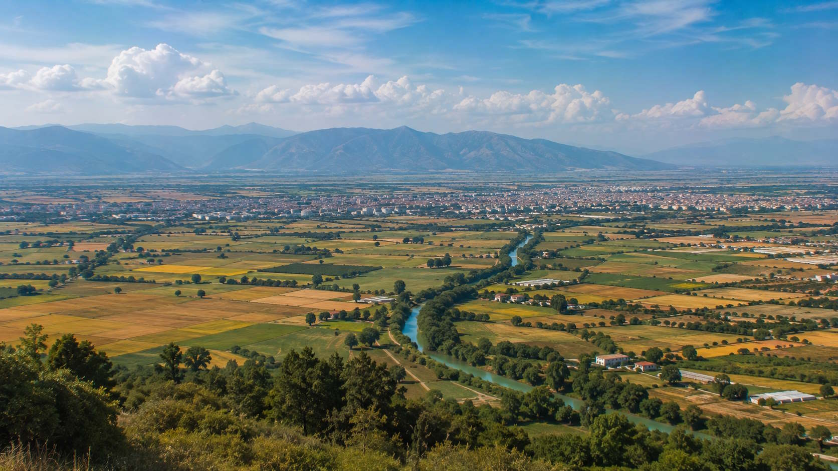 Larissa and the fertile Thessalian plain with farmland and mountains in Greece
