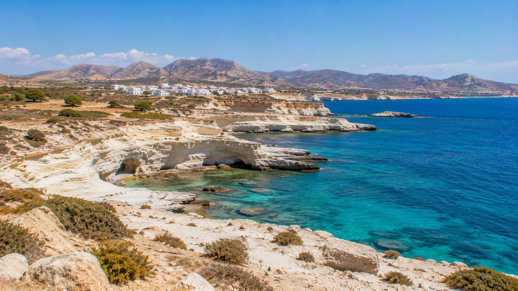 White volcanic coastline and turquoise Aegean waters on Milos island, Greece