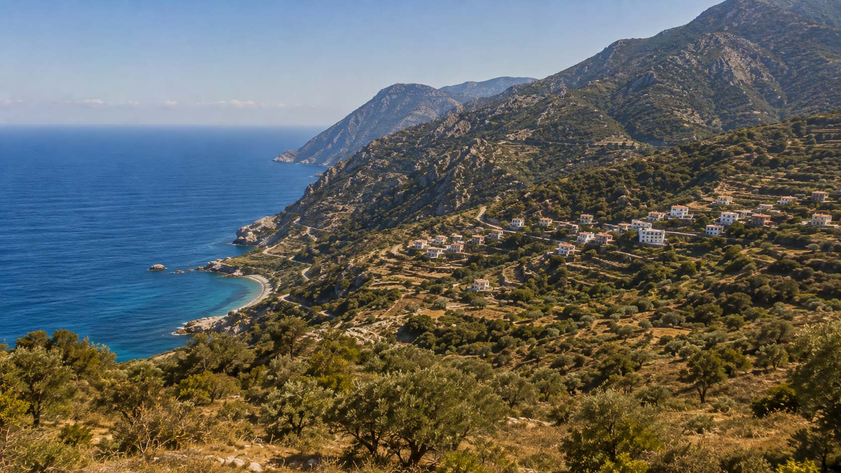 Rugged mountains, hillside settlement and Aegean coastline in Ikaria, Greece