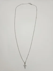 Silver-tone chain necklace with small clear stone cross pendant