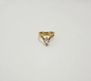 Gold-tone ring with marquise-shaped clear stone and small accent stones