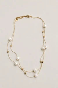 Gold-tone layered necklace with pearl-style beads from VIORÉA Jewellery in Stuttgart