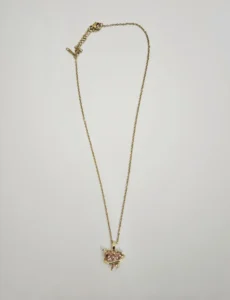 Gold-tone necklace with pink planet-inspired pendant and decorative stones