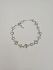 Silver-tone bracelet with square clear stones and floral decorative details